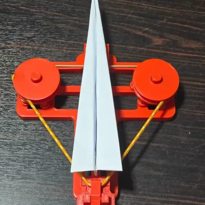 Rubber band paper plane launcher