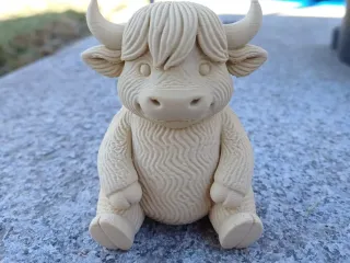 Little fluffy horned cow