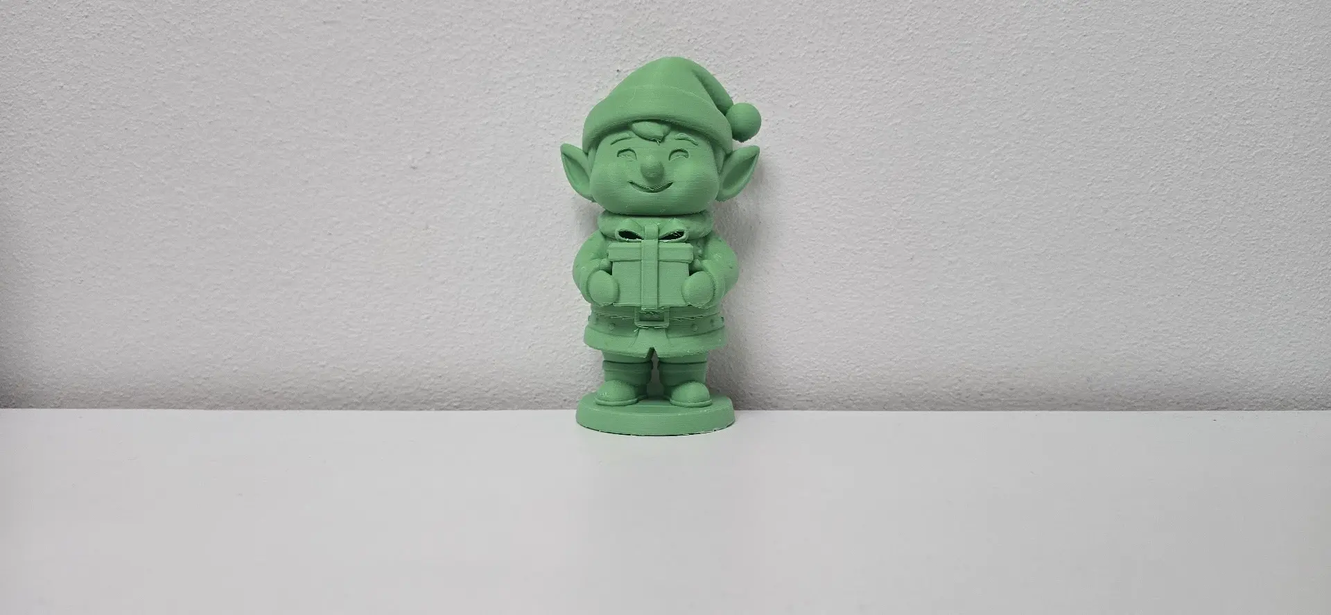 Smiling Elf Holding Gift Christmas Figurine