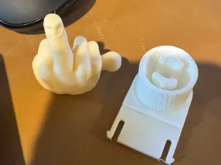 Hard hat toy holder with middle finger