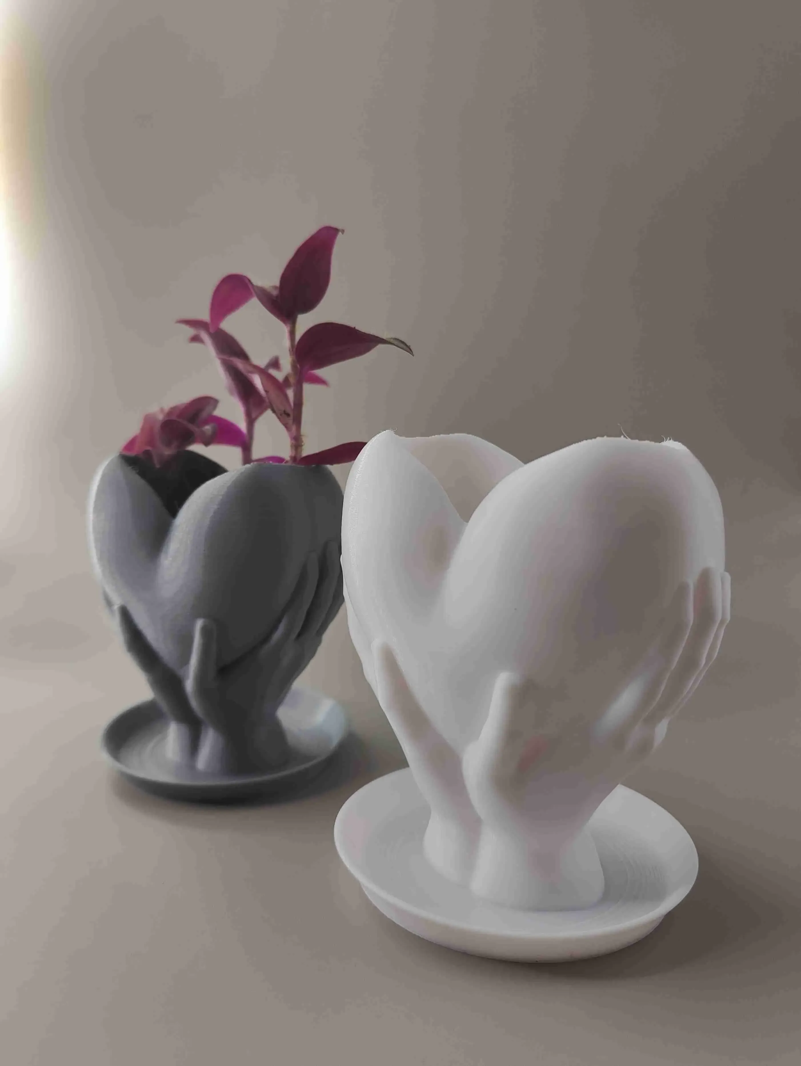 Hands holding heart planter with drainage