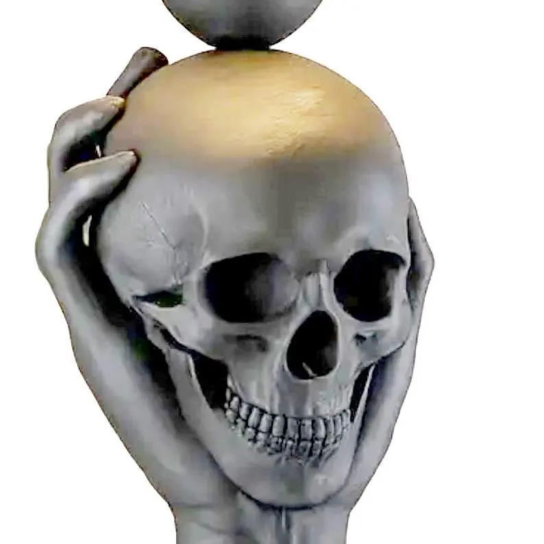 Creepy hand holding creepy skull that's a creepy lamp