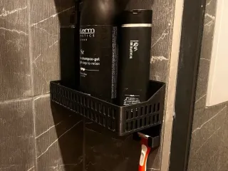 Bathroom shelf with a razor holder