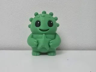 Smiling Spiky Monster with Star Christmas Figure