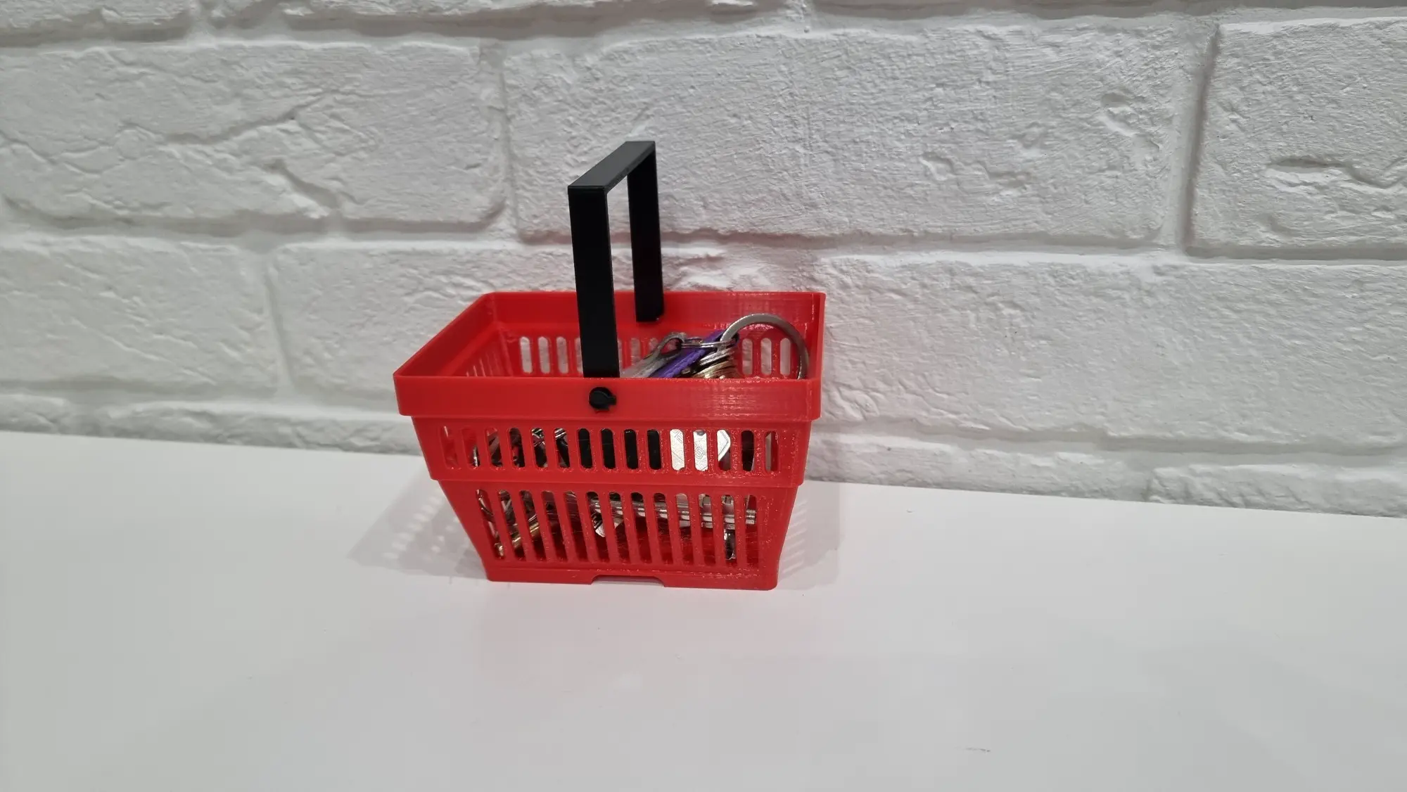 A key case in the form of a shopping basket