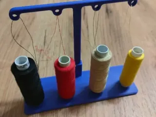 Thread guide for sewing machine for four spools