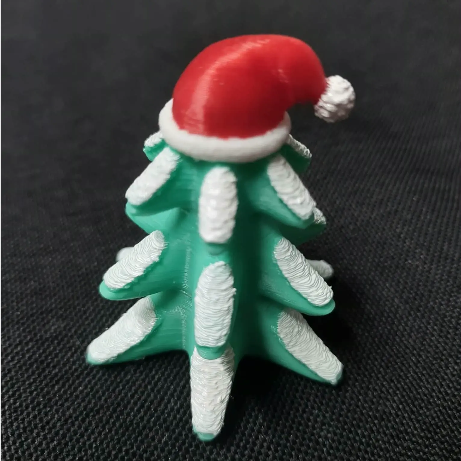 Snowy Christmas Tree wearing Santa's Hat Figurine