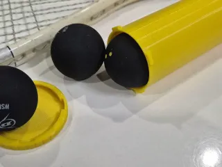 Storage container for squash balls