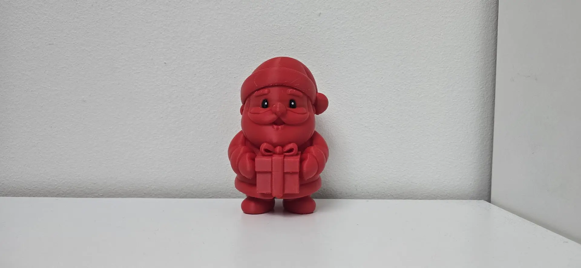 Jolly Santa Holding Gift Christmas Figurine