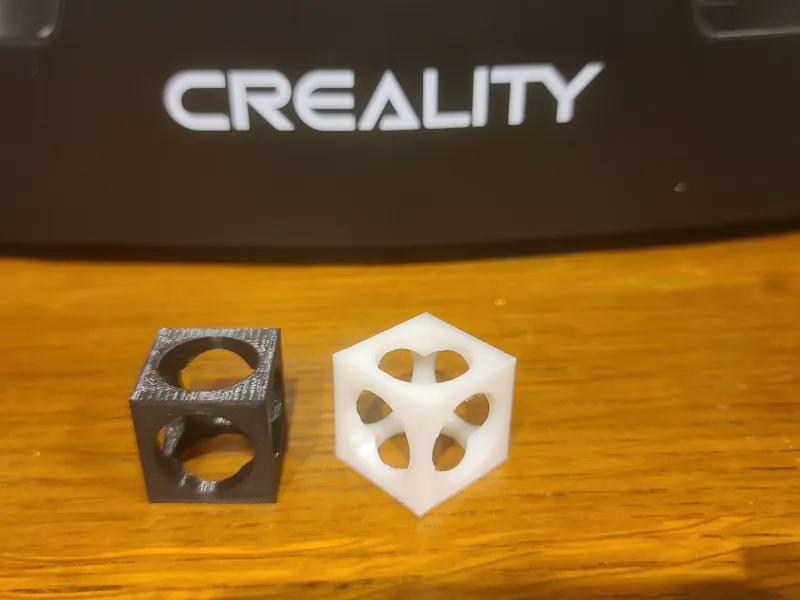 cube extruded by 3 cylinders, first try with fusion