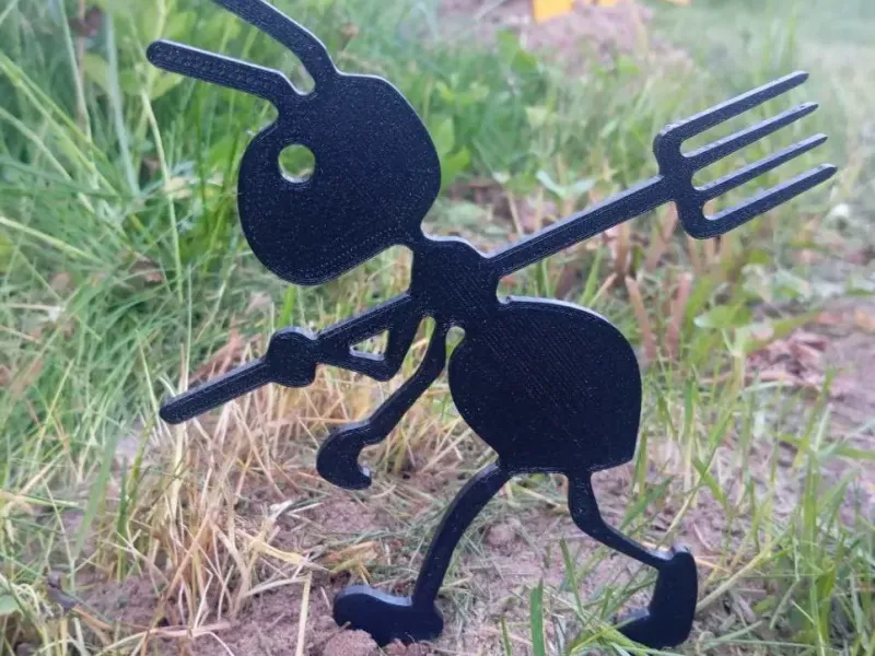 Garden figure of an ant with a pitchfork
