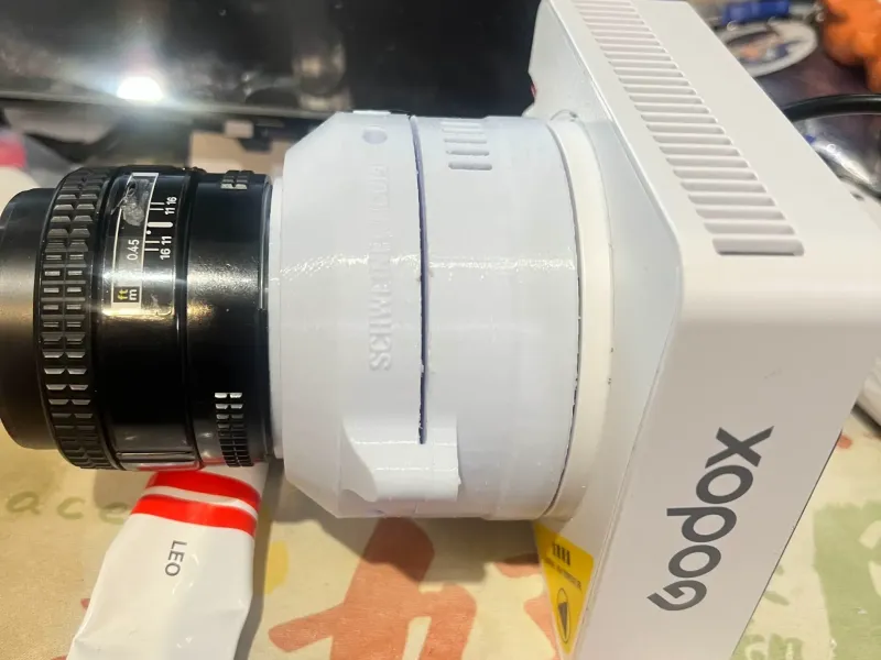 A GOBO with godox mount. build in NIKON F Mount Lens.