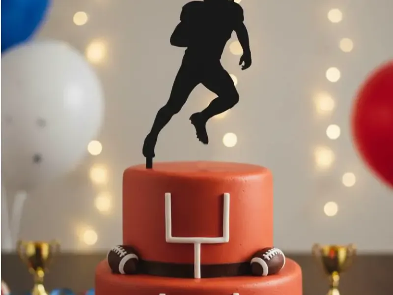 An American football player cake topper