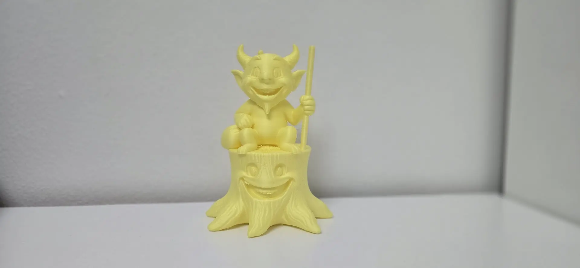 Cheerful Devil on a Tree Stump Figurine