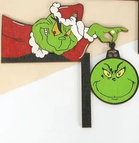 door frame grinch holding ornament