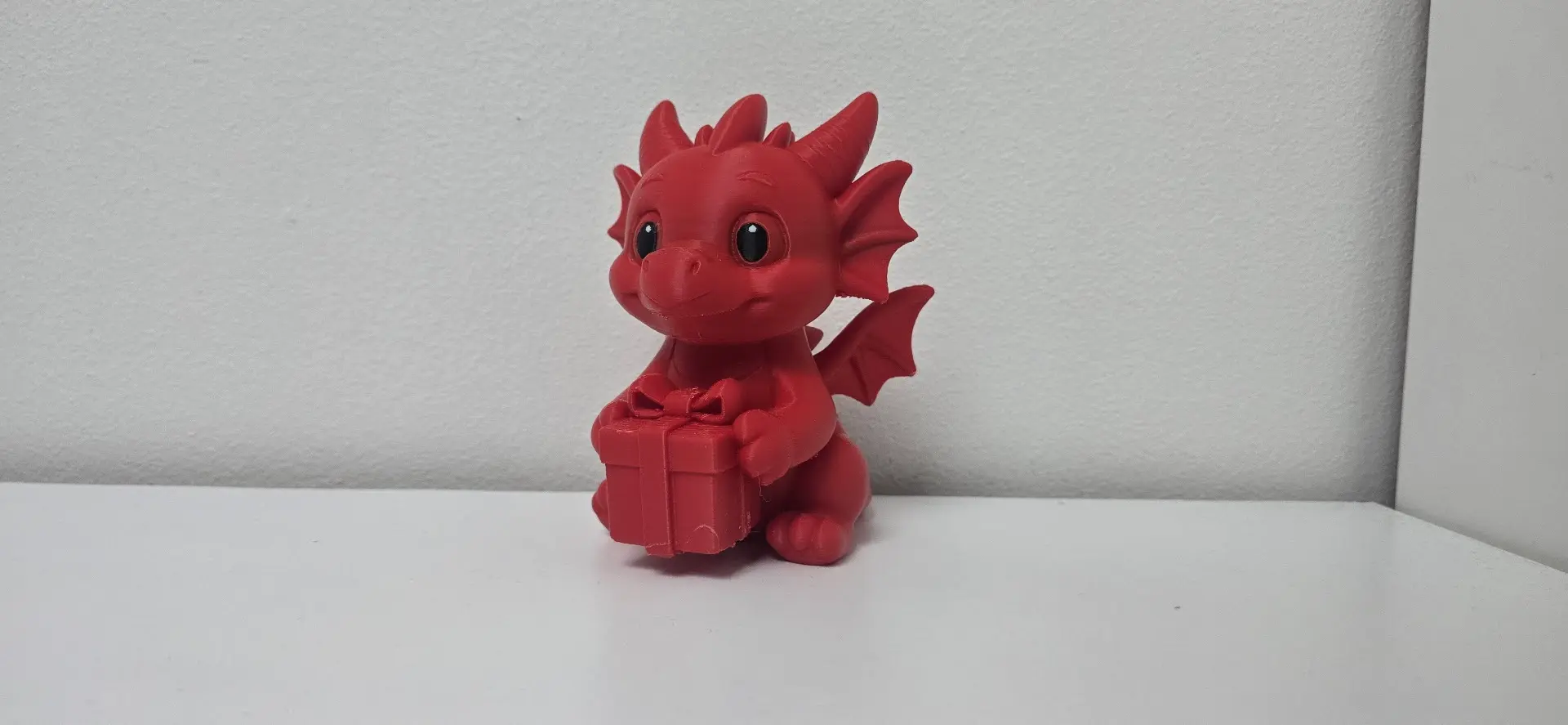 Baby Dragon Holding Gift Christmas Figurine