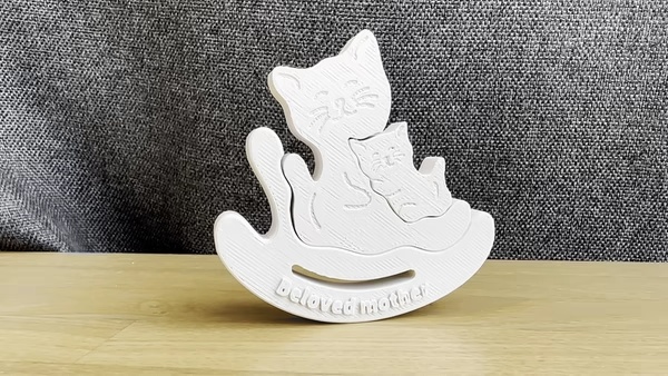 Mom cat and kitten in a chair