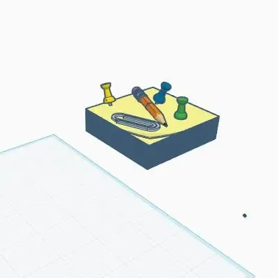 A fun desk thing with a sticky note pad pencil and thumbtack
