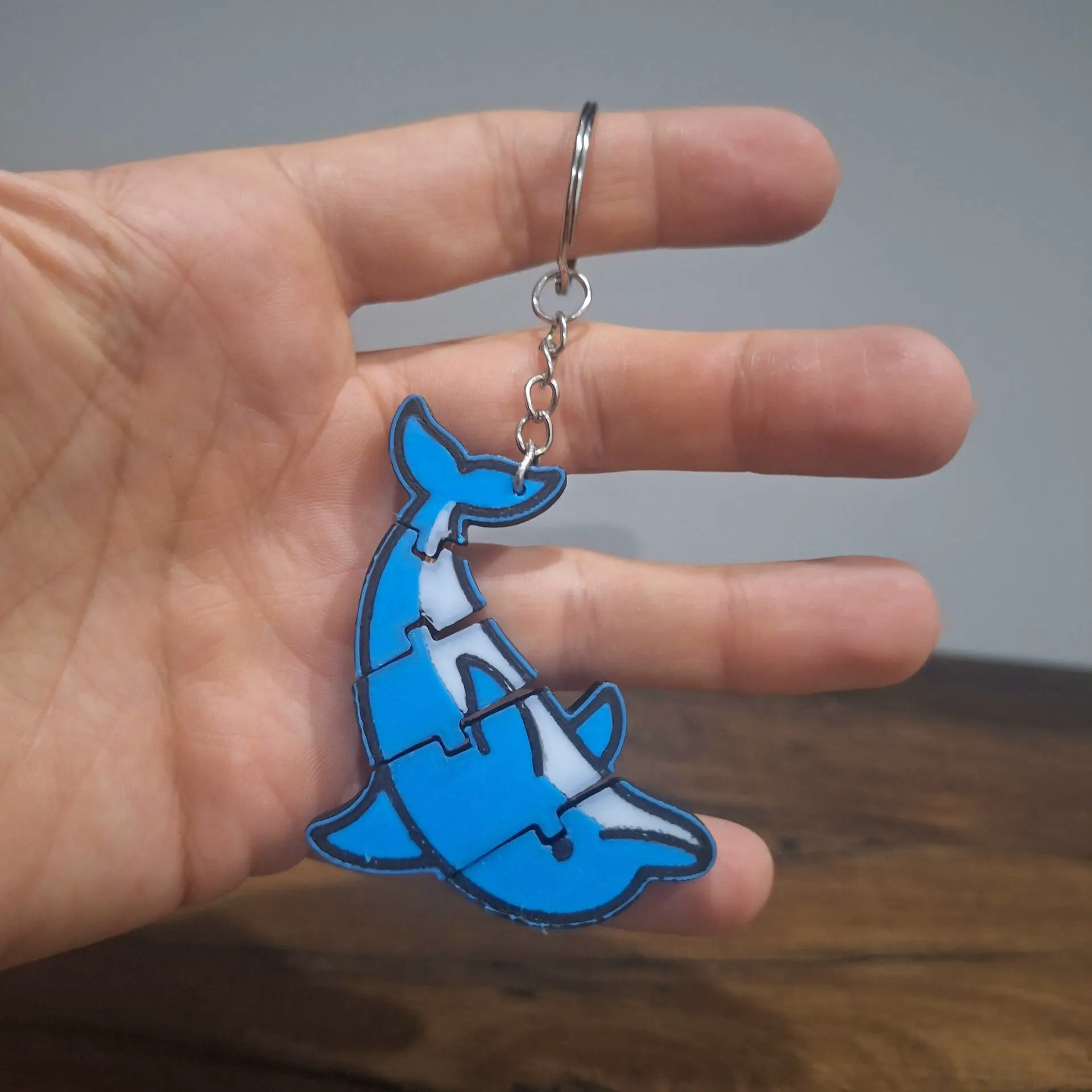 Flexible keychain in the shape of a dolphin