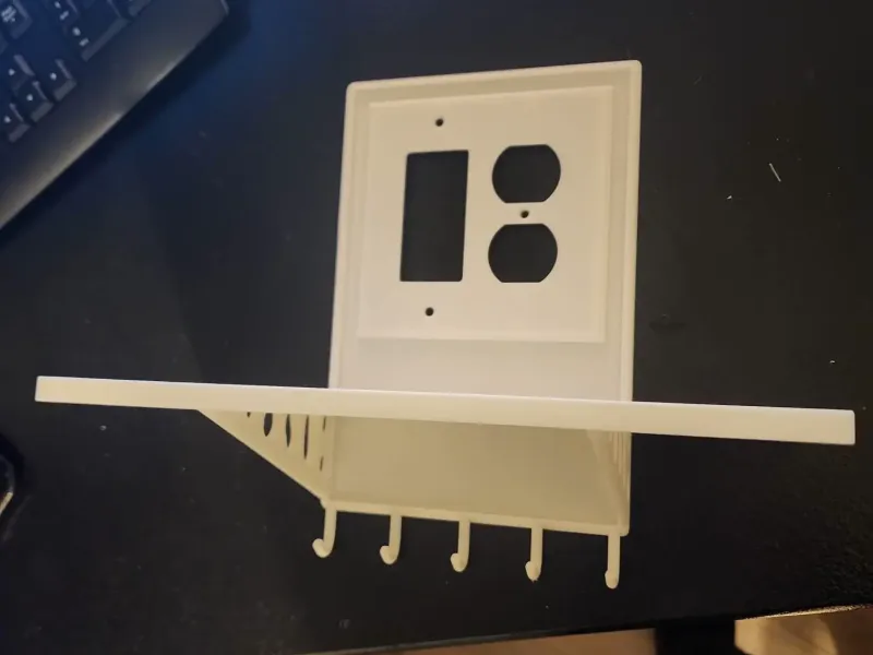 Double outlet/switch plate with shelf and hooks