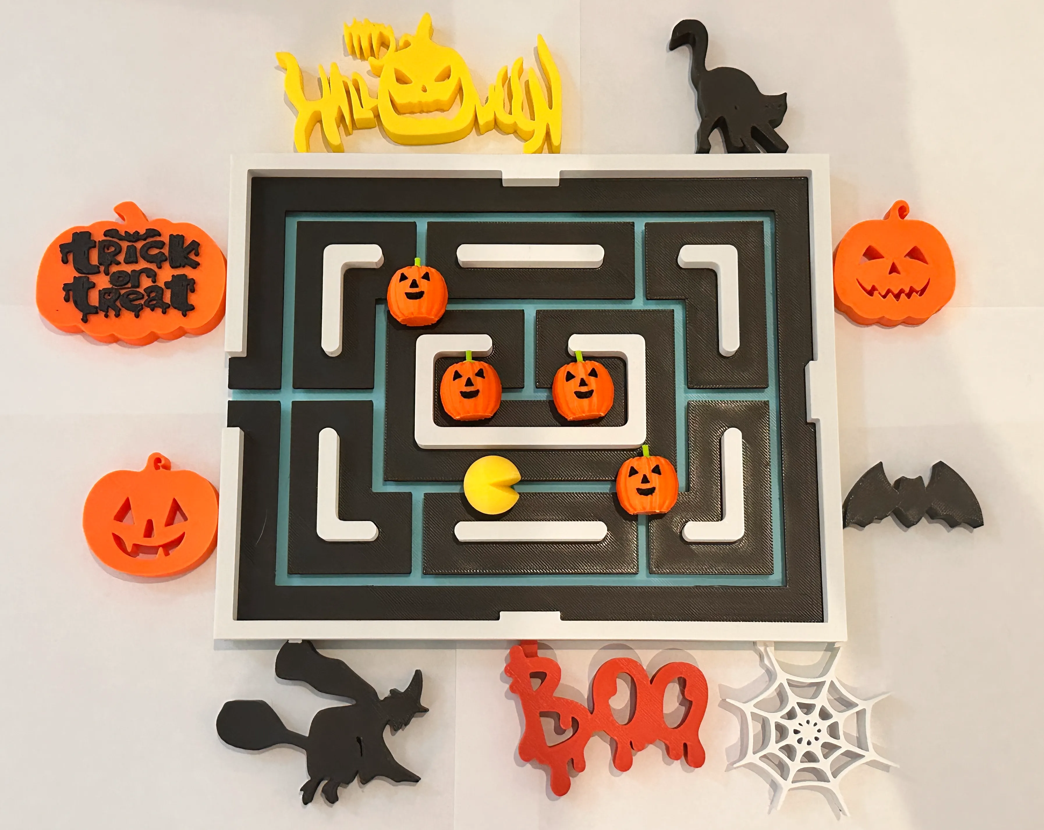 Pac Man fridge magnet with Halloween attachments.