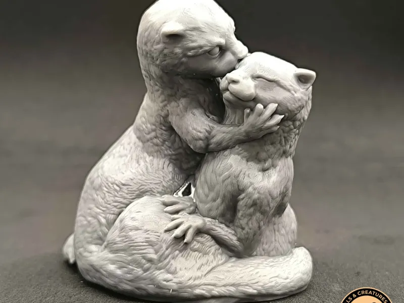 Two otters kiss