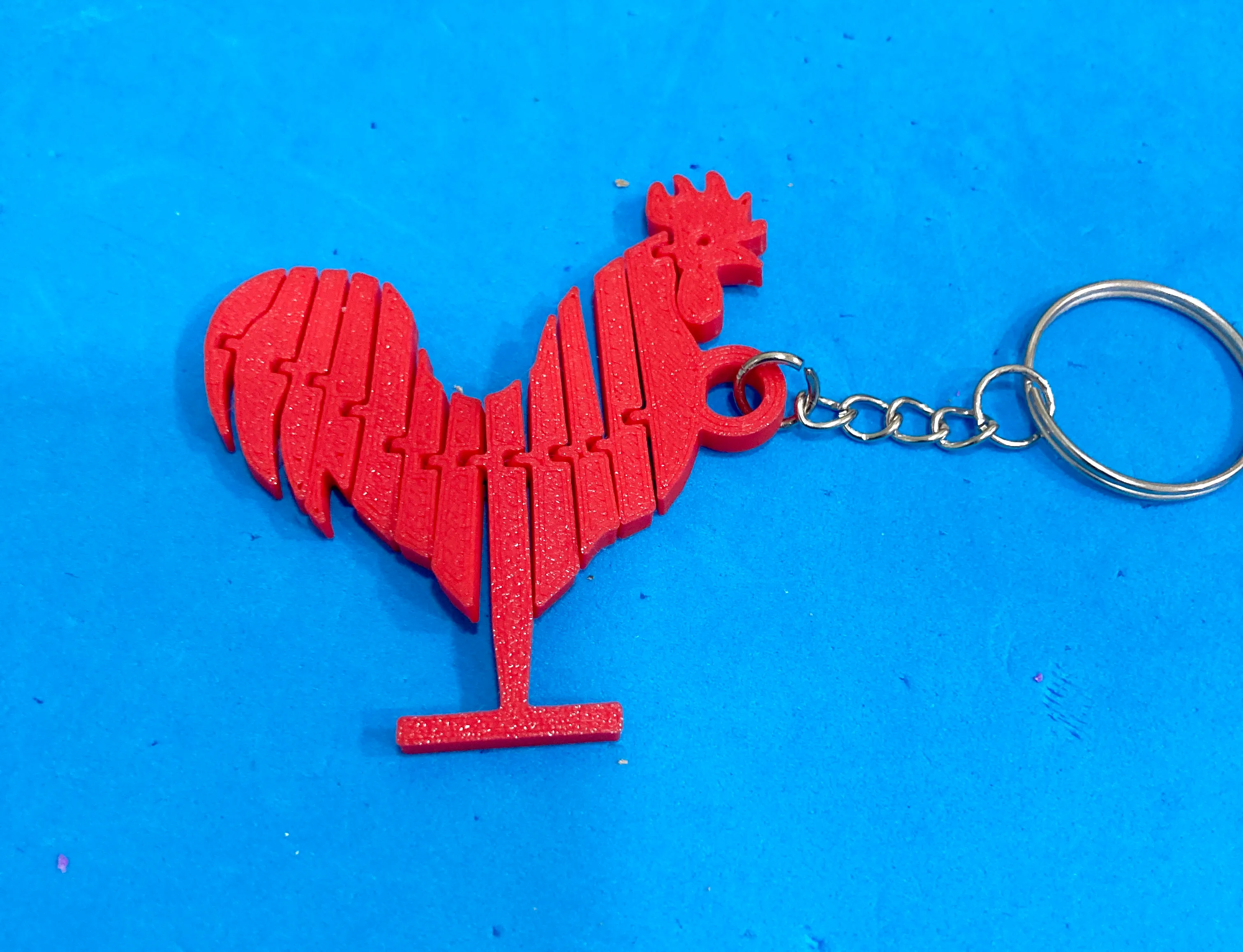 GELEDE KIP SLEUTELHANGER / LLAVERO GALLO ARTICULADO