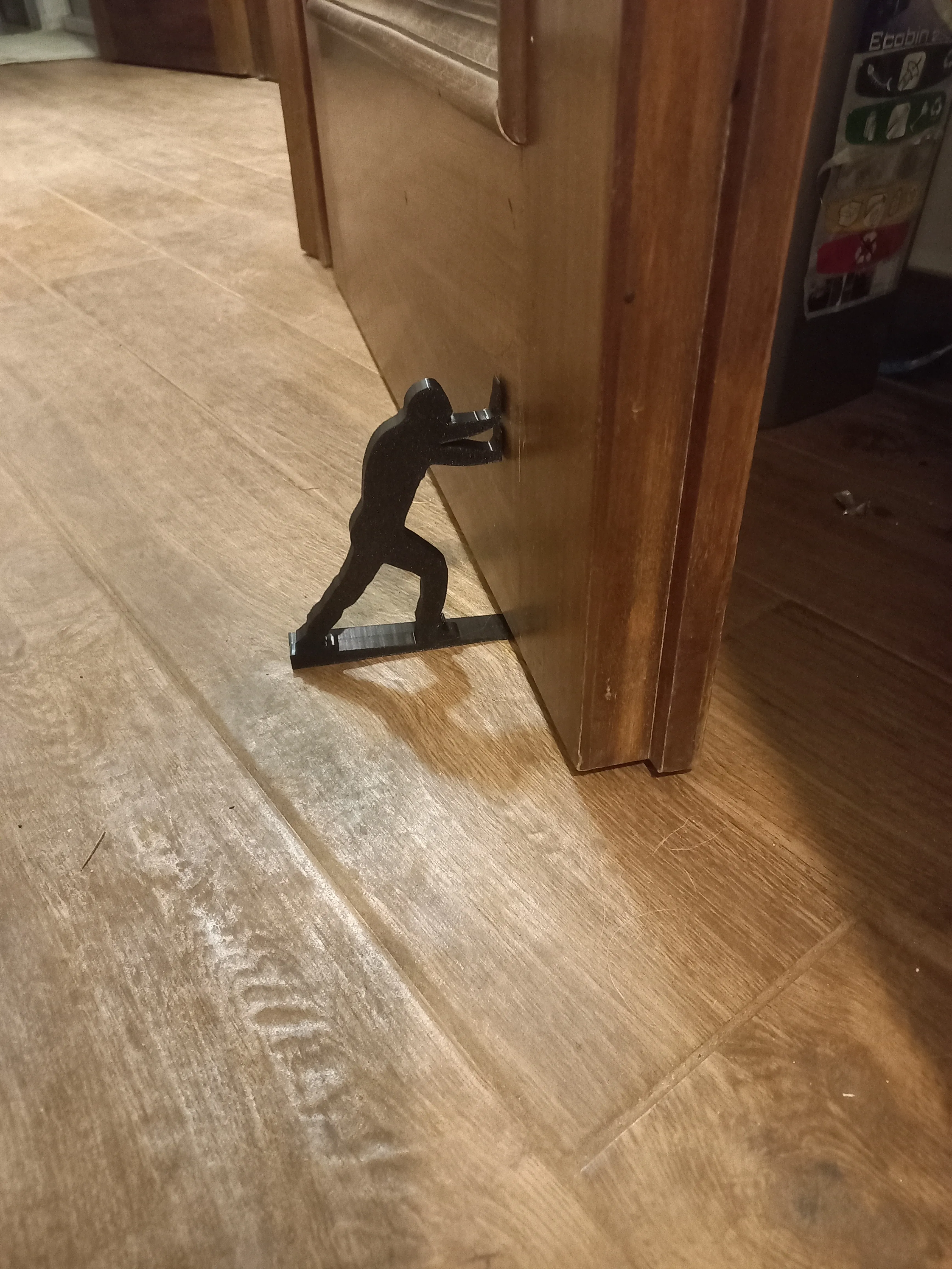 Pushing man book holder / door stop