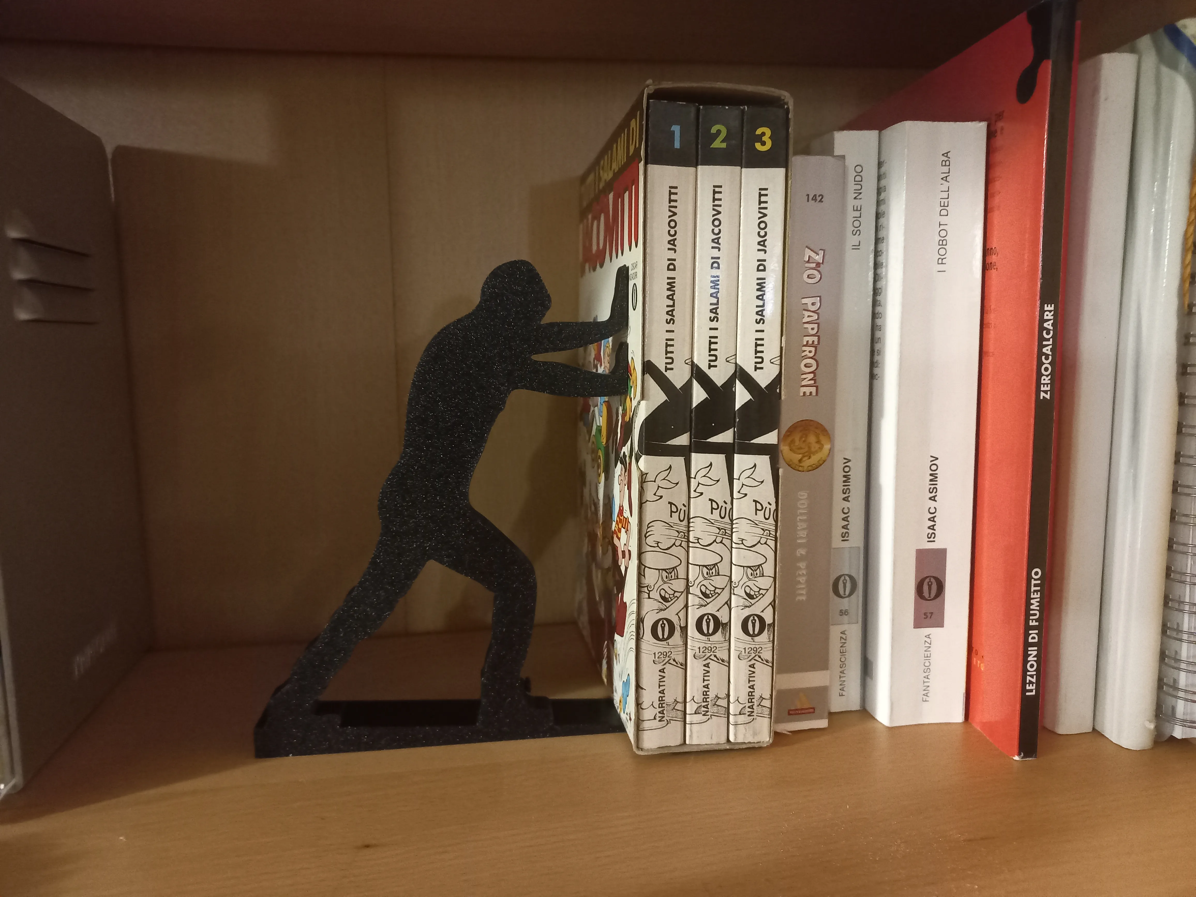Pushing man book holder / door stop