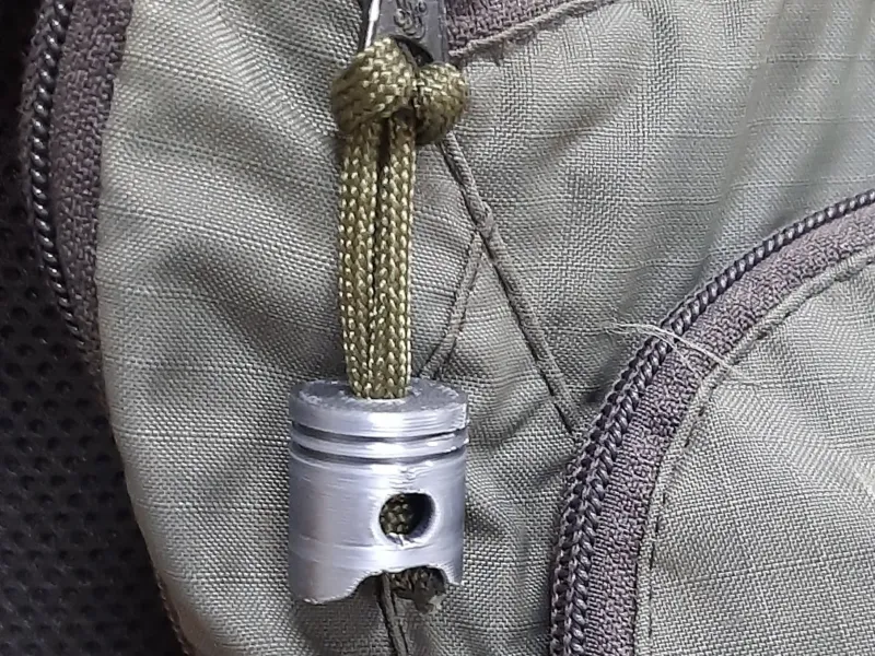Piston paracord zipper pull
