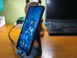 Phone stand for side charging cable
