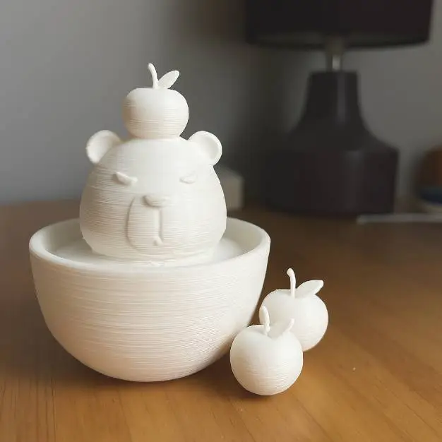 Capybara in a bowl with apples