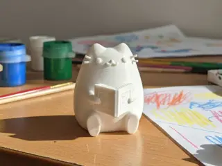 Pusheen the reader figurine