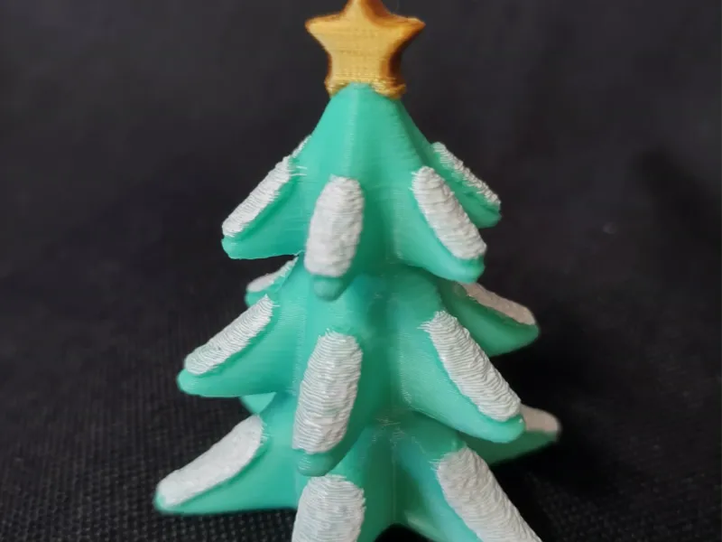 Snowy Christmas Tree topped with a Star Figurine