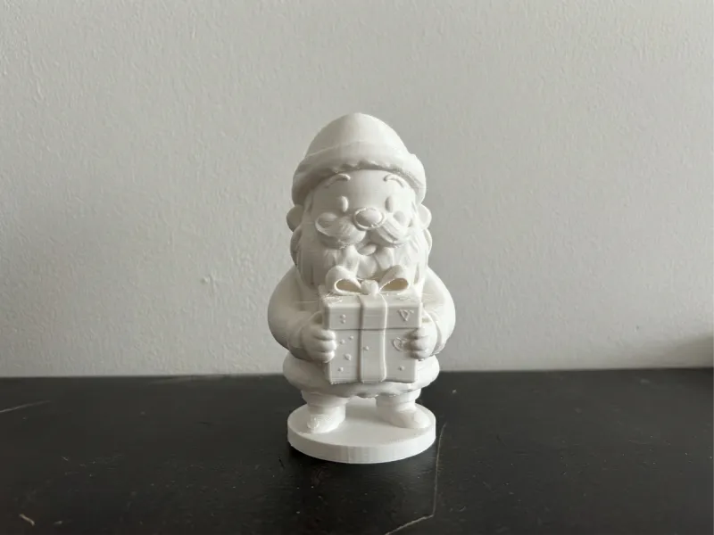 Cute Santa Claus Holding Gift – Christmas Figurine