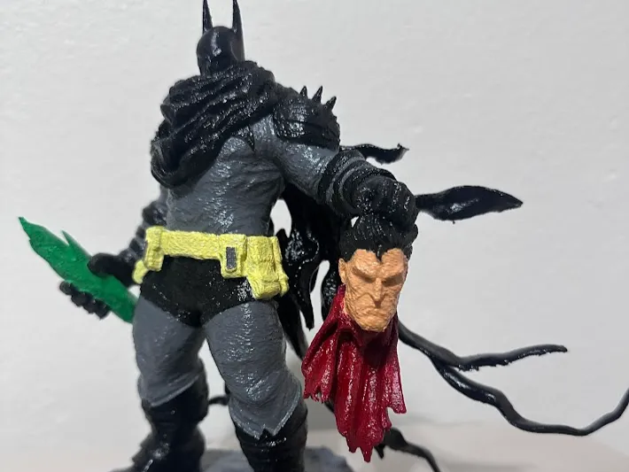 Batman holding Superman’s Head