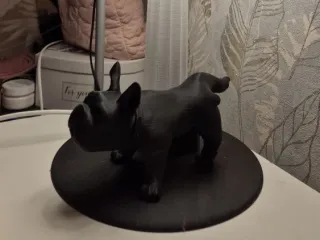 A table lamp with a pissing French bulldog