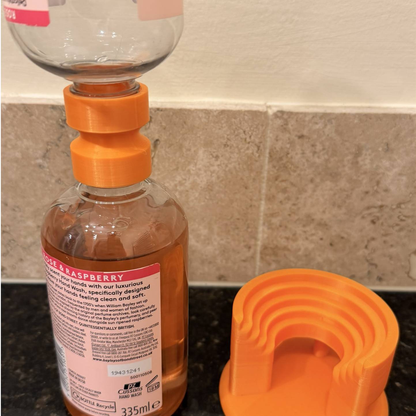 Holds bottles upside down to get the last part of the liquid