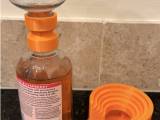 Holds bottles upside down to get the last part of the liquid-0
