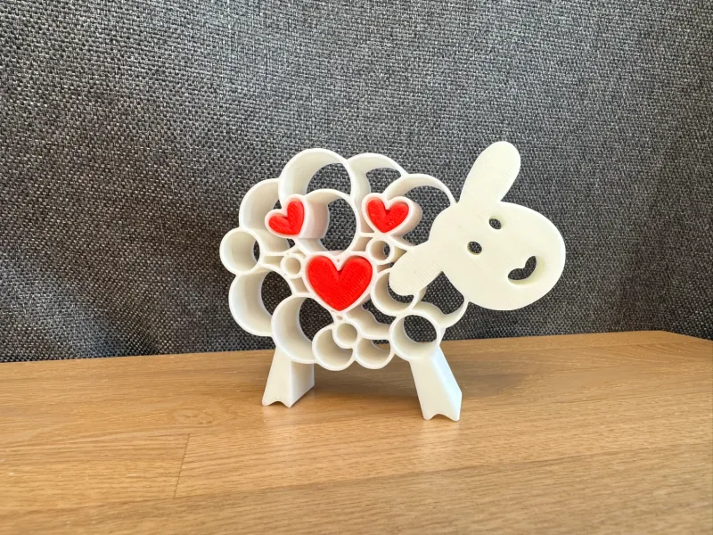 Sheep figurine with hearts
