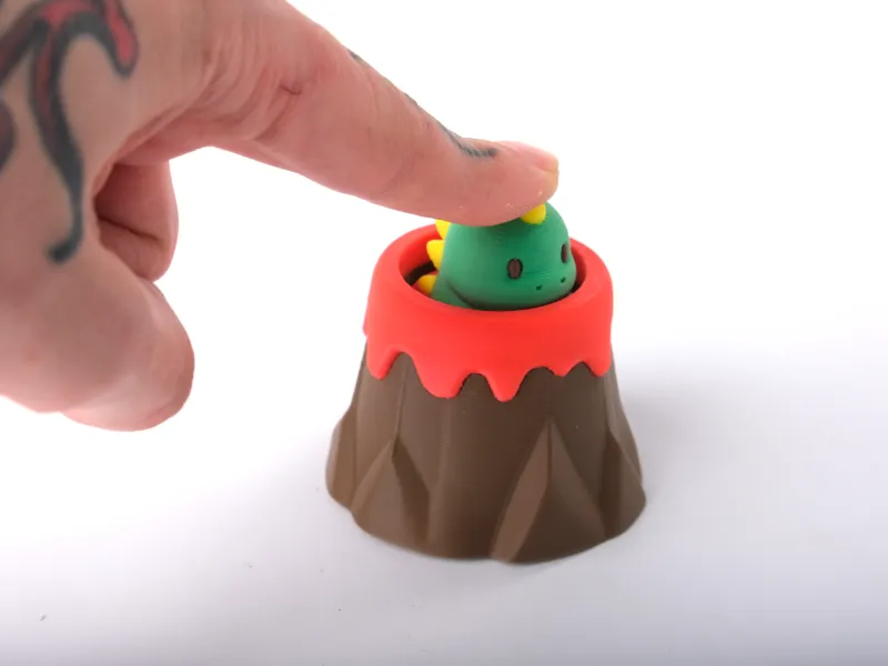 Juguete Clicker de Dino Volcánico - Coleccionable Antiestrés