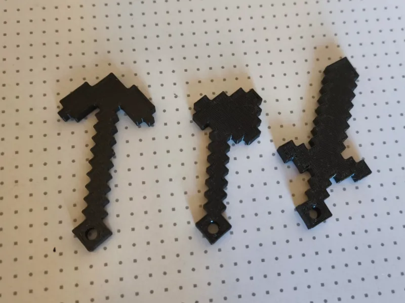 Minecraft keychain with a sword, pickaxe, and axe