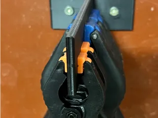 Wall mounted spring clamp holder