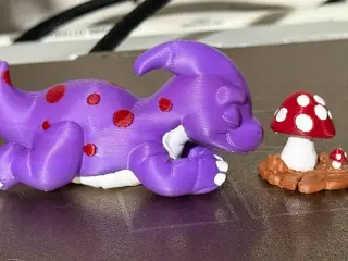 cute dino sleeping next to mushrooms