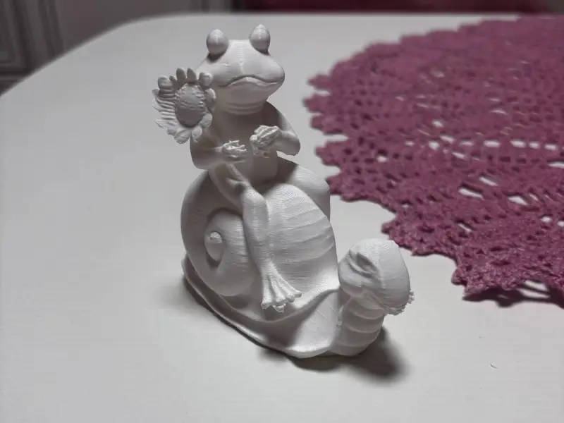 snail riding a frog garden decoration
