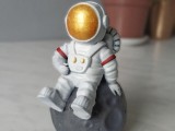 An astronaut is sitting on an asteroid-1