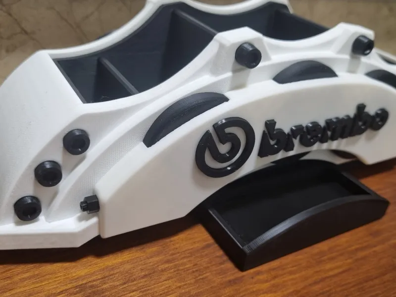 A desk organizer shaped like a brake caliper
