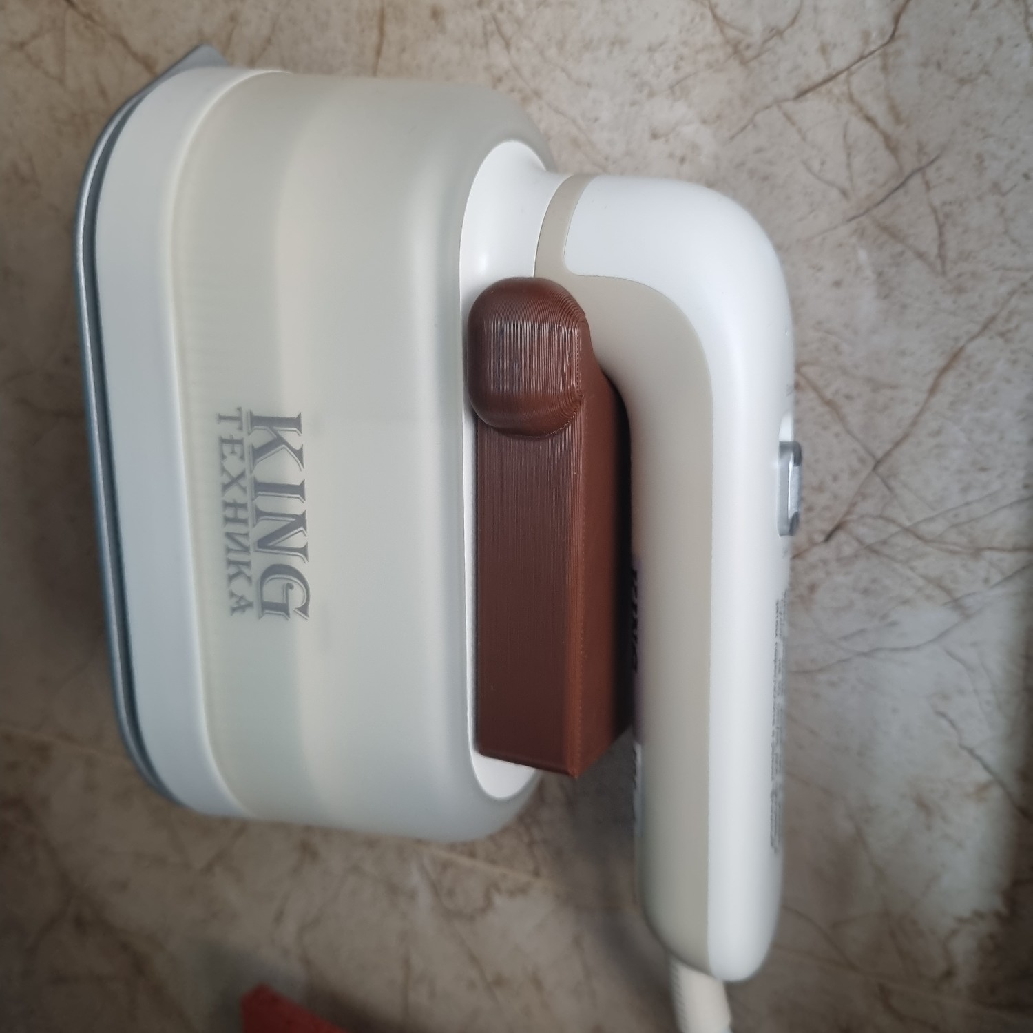 Wall-mounted holder for hand-held steamer